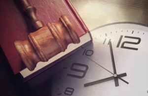 Clock, Judge's Gavel and Book. Concept of Legal timing