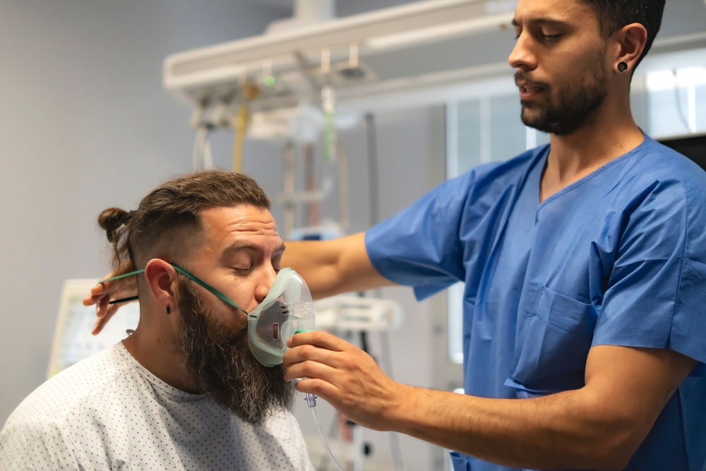 Patient receiving breathing treatment after toxic exposure